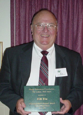 Bill Fox holding his Distinguished Alumni Award