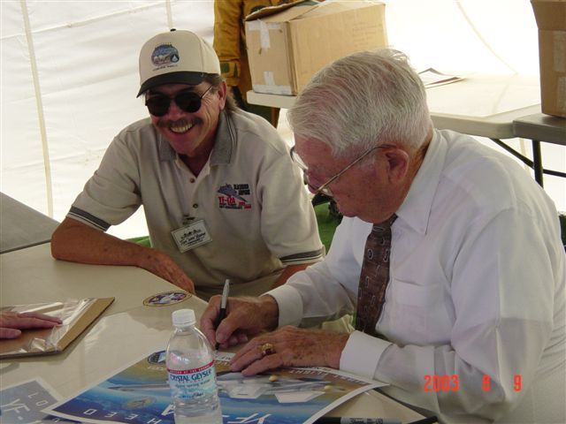 Jim Eastham signing poster commemorating his piloting the first flight of the YF-12.