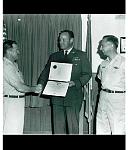 Major Trapp being presented Air Medal for his operations on Mt. Baldy. Burt Barrett presenting medal and Ray Schrecengost looking on